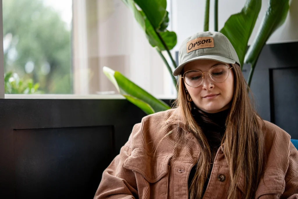 Woman Sitting At Cafe Custom Richardson Hat With Applique