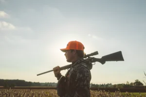 Hunter Wearing Custom Richardson Blaze Orange Hat With Embroidered Logo