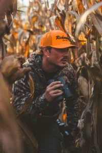 Hunter Wearing Custom Richardson Blze Orange Hat With Embroidered Logo