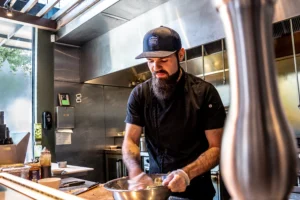 Man Working In Kitchen Wearing Custom Richardson Hat With Logo Patch Decoration