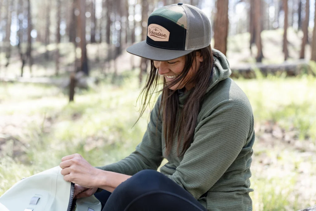 Woman Hiking Wearing Custom Richardson Hat With Leather Decoration