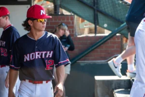 Baseball Player In Dugout Wearing Custom Richardson Uniform and Hat
