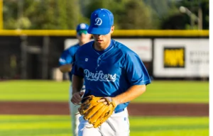Baseball Player Jogging on Field Wearing Richardson Performance Team Series Uniform And Hat