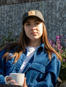 Woman Drinking Coffee Wearing Custom Richardson Hat With Genuine Cork Decoration