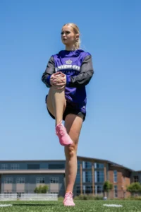 Softball Player Stretching In Richardson Dart Performance Hoodie