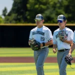 Baseball players walking holding their baseball mitts