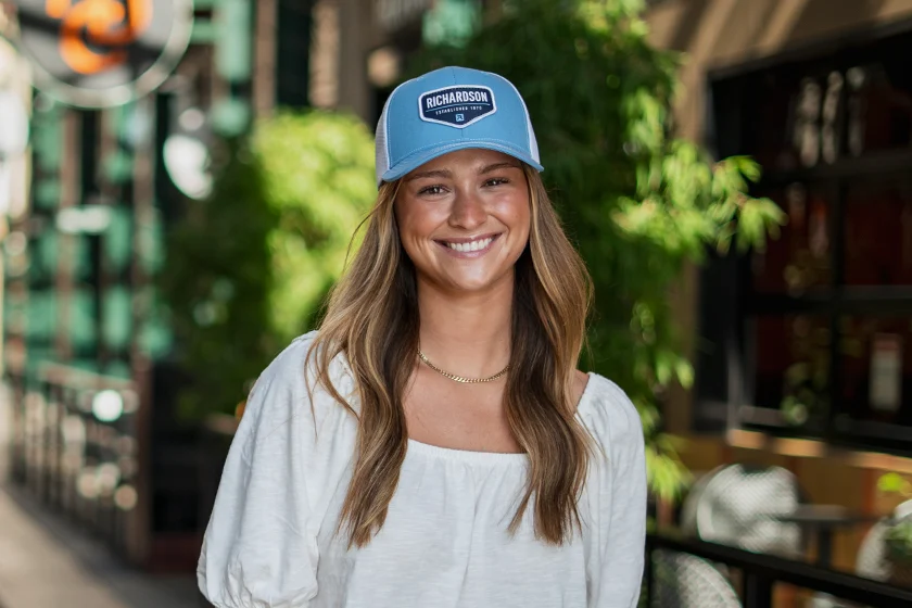 Woman wearing custom Richardson trucker hat with Richardson logo