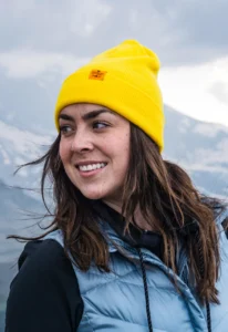 Woman wearing yellow beanie with custom clip label