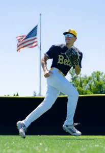 Baseball player wearing custom baseball uniform running on field