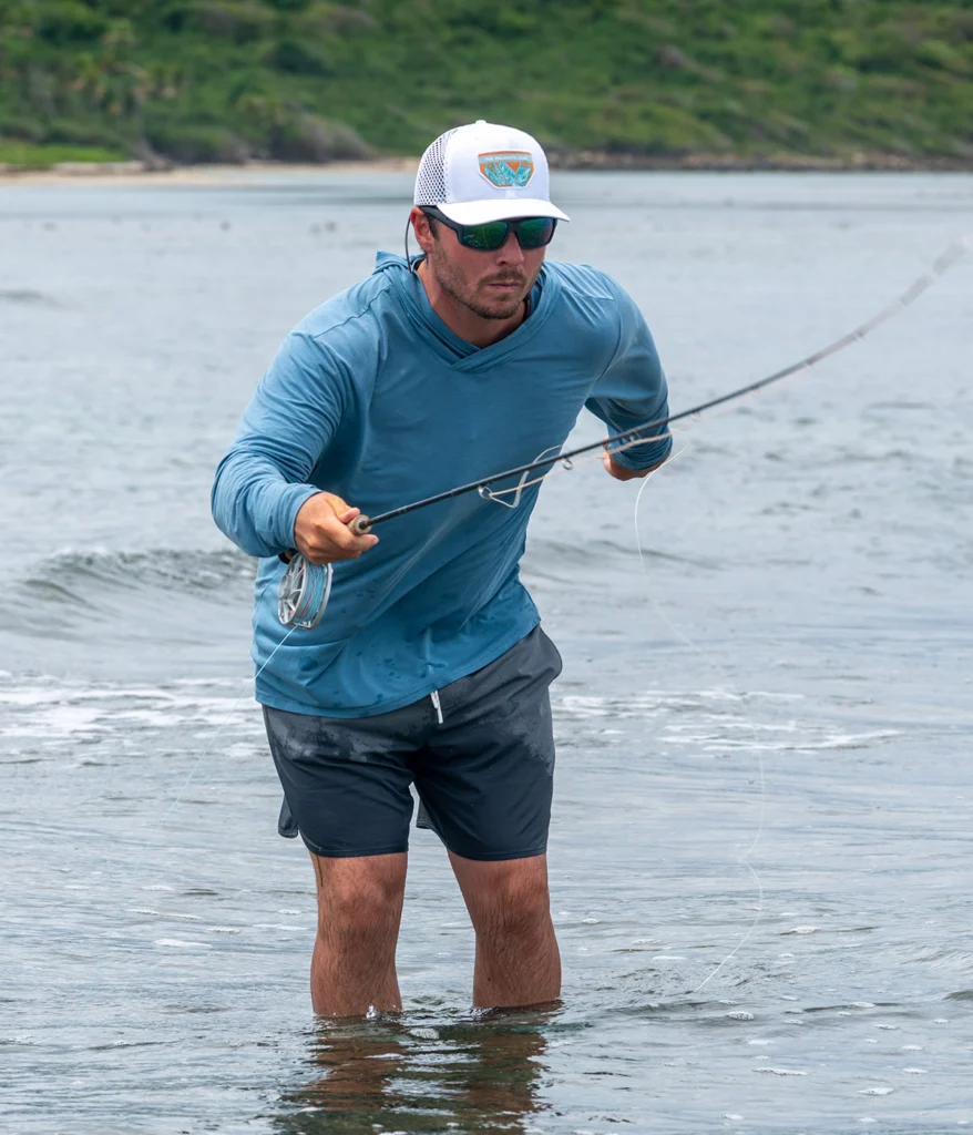 Man in river fly fishing wearing custom Richardson hat with woven label