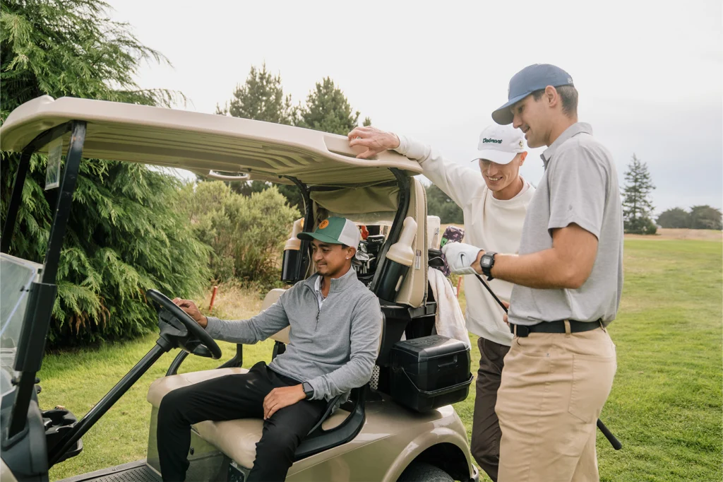 Golfers next to golf cart wearing custom Richardson hats