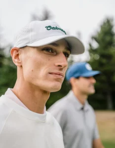 Golfer wearing custom Richardson hat in white with green embroidery
