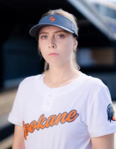 Softball player wearing custom softball uniform and visor from Richardson