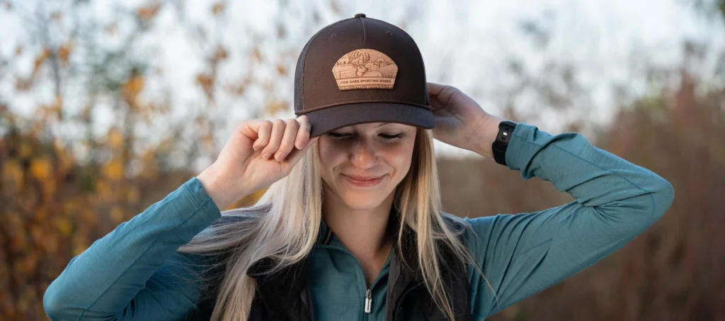 Woman putting a custom richardson hat on