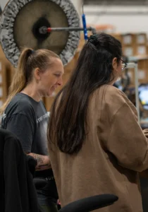 Two employees working together in a production area.